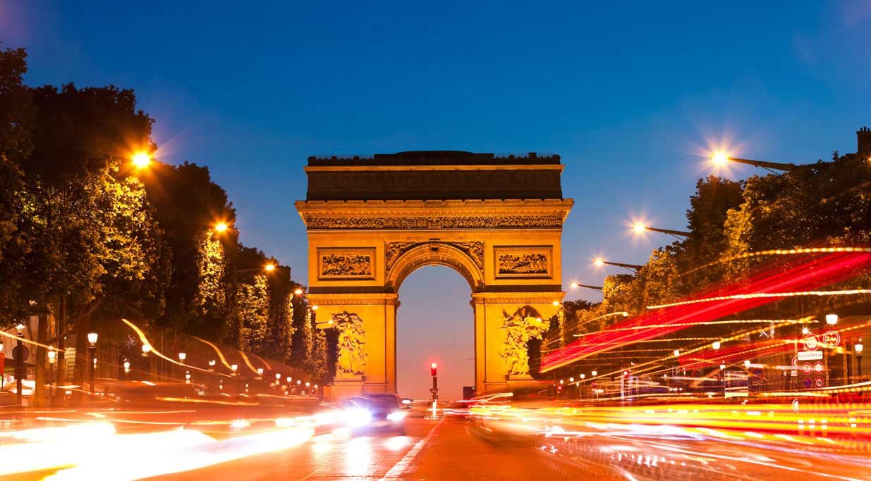 The Arc de Triomphe in Paris at night.