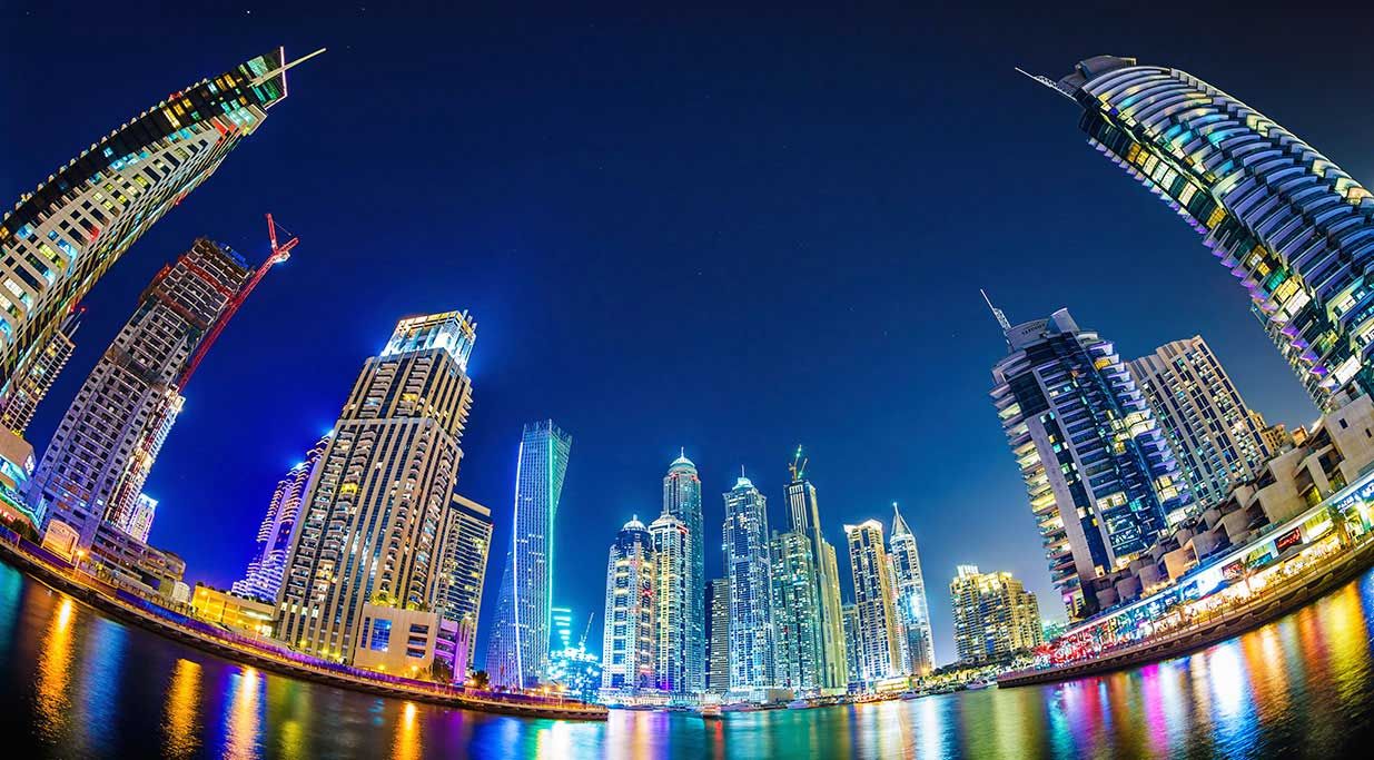 The Dubai, skyline photographed at night.