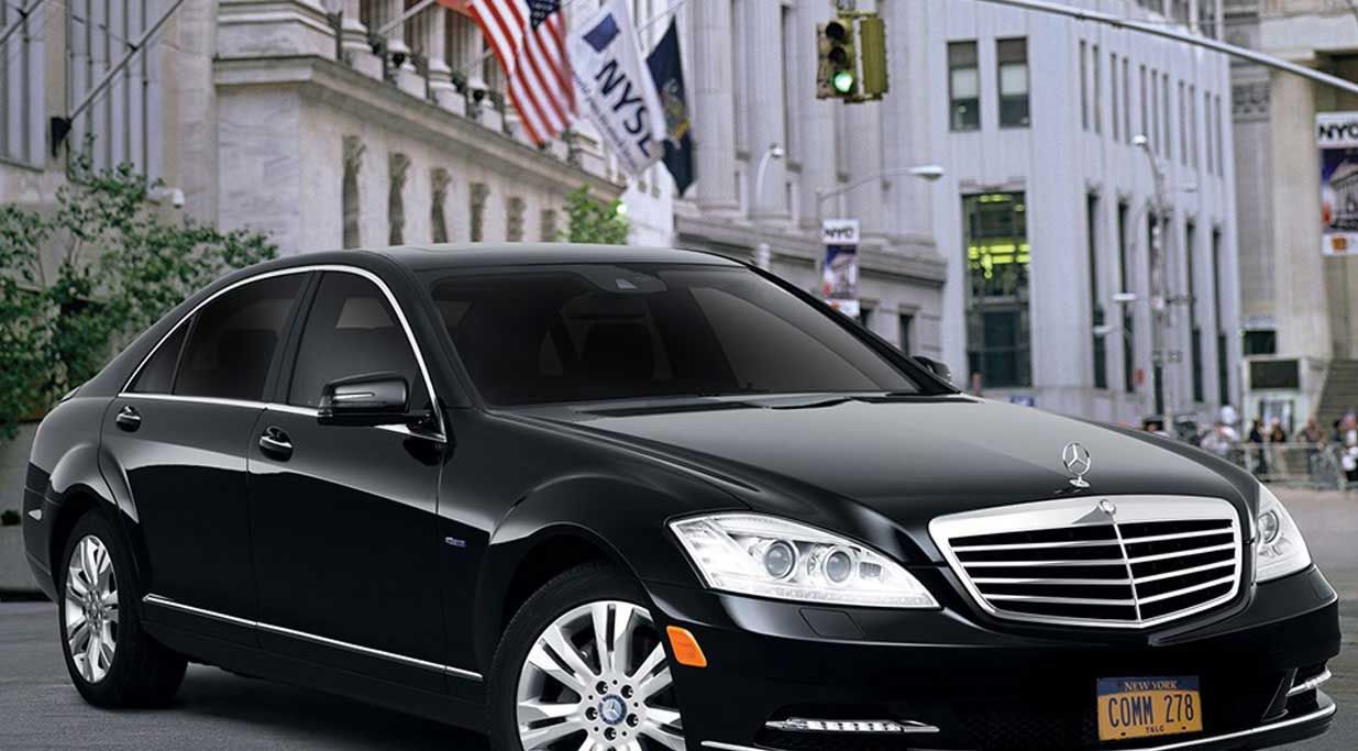 A luxury sedan from Commonwealth Worldwide’s fleet, parked in the heart of New York City’s financial district.